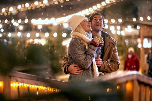 Man and woman outdoor in winter for a romantic holiday night