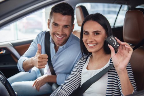 couple in car holding keys