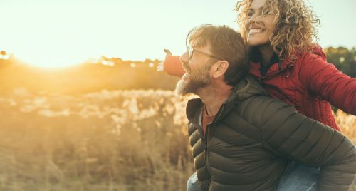 Happy couple having fun together outdoor during sunset
