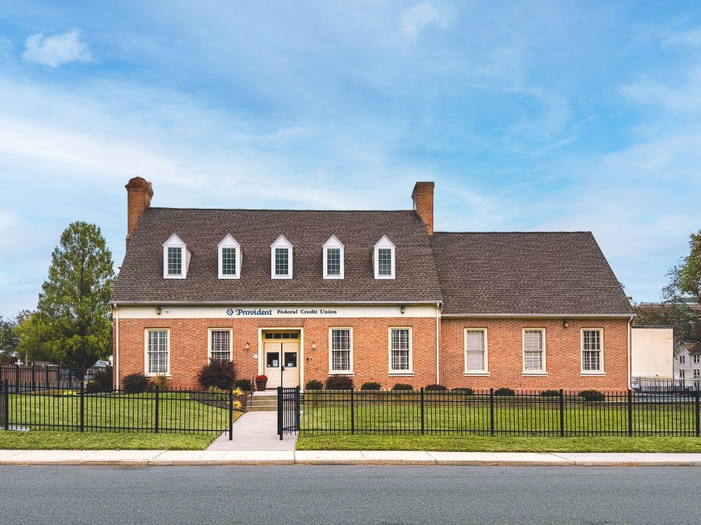 Adult man and woman in casual clothing walking peacefully through a park.
