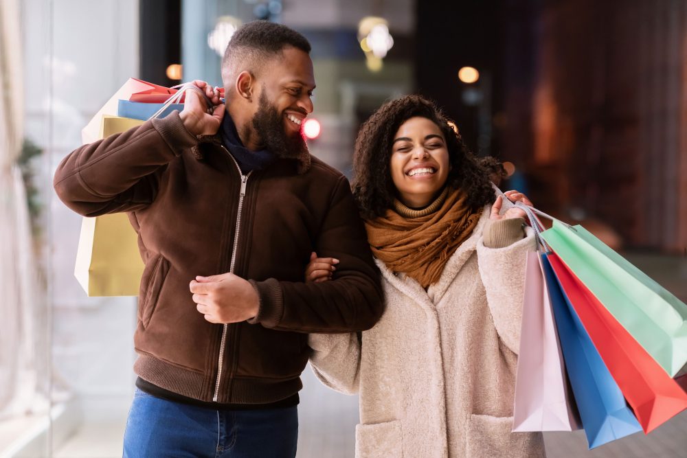 Happy couple walking with shopping bags