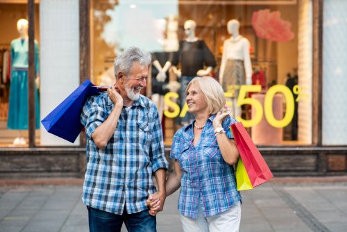 Happy senior couple with shopping bags