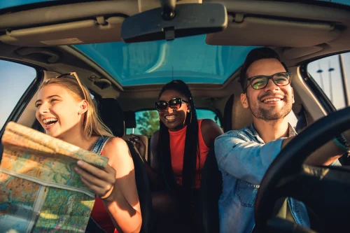 Three best friends enjoying traveling at vacation in the car